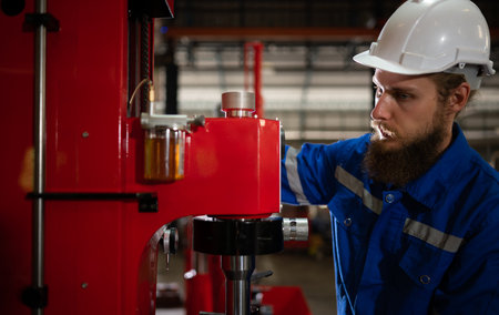 Mechanical engineers are checking the working condition of the new machine after completing the...