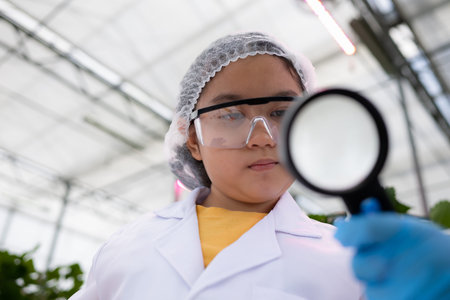 In the closed strawberry garden, a young scientist conducts a strawberry nutrient production...