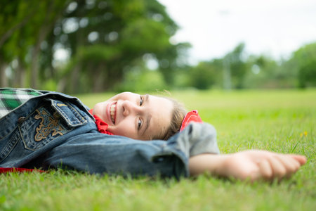 On a beautiful day in the park, a little girl enjoys her vacation.