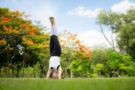 Young female with outdoor activities in the city park, Yoga is her chosen activity.の写真素材