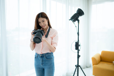 Beautiful asian woman Vlogger and blogger recording video for social media content live streaming at...