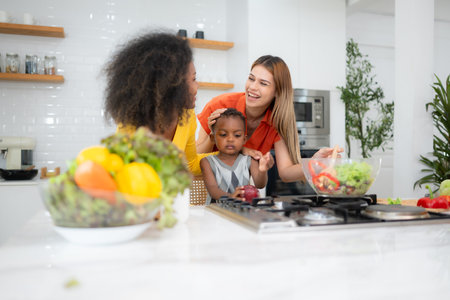 Happy multiethnic family cooking together in the kitchen at home.の写真素材