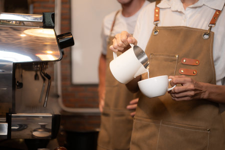 Barista pouring coffee into a cup in coffee shop, closeupの写真素材