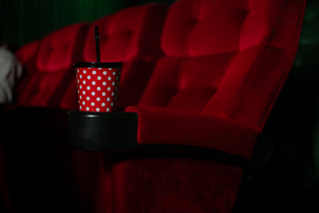 Cinema concept. People watching movie at cinema drink water and eating popcornの写真素材