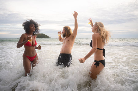 Group of friends having fun on the beach. Young women having fun on the beach.の写真素材