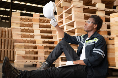 Young workers work in a woodworking factory, Sit back and relax after checking the wooden planks