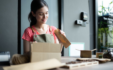 Young woman working in coffee shop, business owner concept.の写真素材