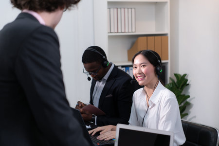 Group of business people wearing headset working actively in office. Call center, telemarketing,...