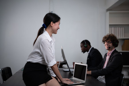 Group of business people wearing headset working actively in office. Call center, telemarketing, customer support agent provide service on telephone video conference call.の写真素材
