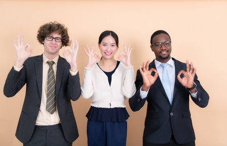 Portrait of group multi ethnic business people together showing ok hand sign with fingersの写真素材