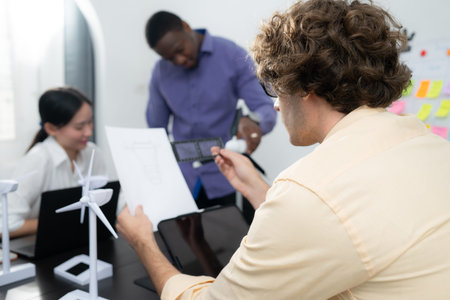 Group of multi-national team of architects and designers is meeting to brainstorm designs for wind...