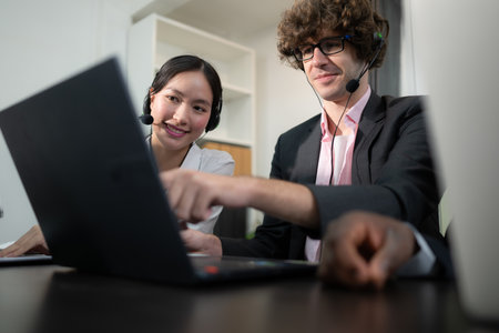 Group of business people wearing headset working actively in office. Call center, telemarketing, customer support agent provide service on telephone video conference call.の写真素材