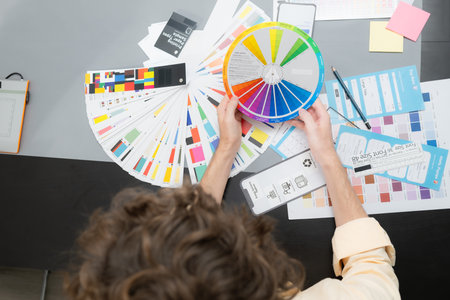 Young male architect and designer are rethinking the choice of color scheme for designing a smartphone application.の写真素材