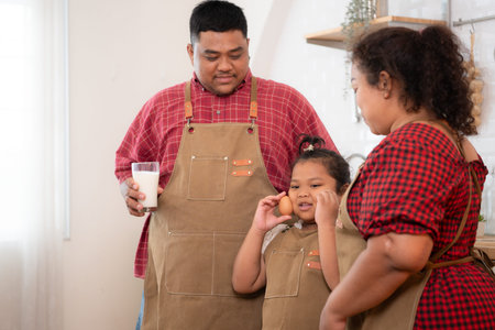 A plus-size family with a father wearing a prosthetic leg, Eat together after cooking and daughter...
