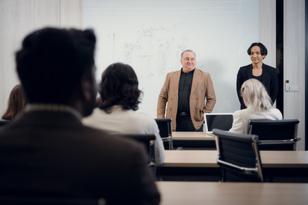 Portrait of a senior businessman giving a presentation to his colleague at officeの写真素材