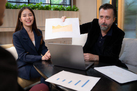 Businessman and businesswoman discussing a project in the meeting room of co-working space