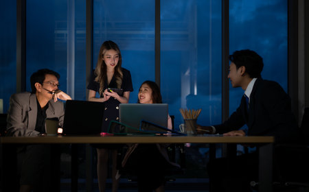 Group of business people working in office at night. Business concept.の写真素材