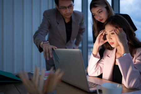 Group of broker international stock traders working actively at night in office, A young woman is working hustle to present a client with friends helping her with information.の写真素材