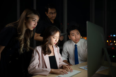 Group of business people working in office at night. Business concept.の写真素材