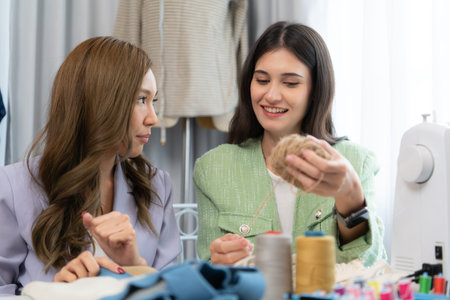 Two female fashion designers are working on a new collection of clothes.