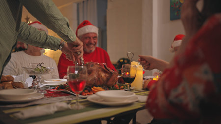 Close-up of senior couple while my son was chopping up a roast turkey for Christmas dinner.の写真素材