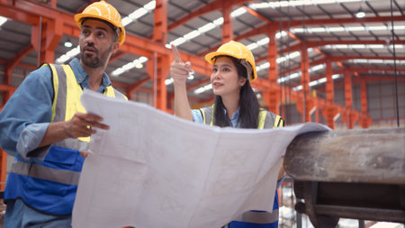 A team of engineers and architects are jointly inspecting factory at the site. It is a massive new facility for making metal sheets as well as a transportation and distribution warehouse.の写真素材