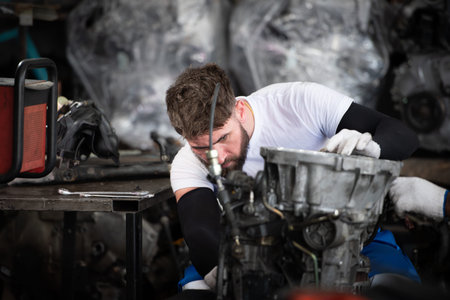 Men repairing car engine in auto repair shop, Selective focus.の写真素材