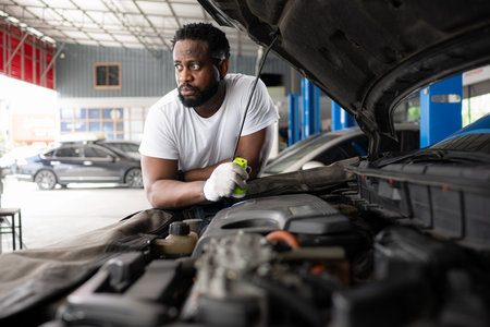 Both of professional auto mechanic working together in auto repair shop.の写真素材