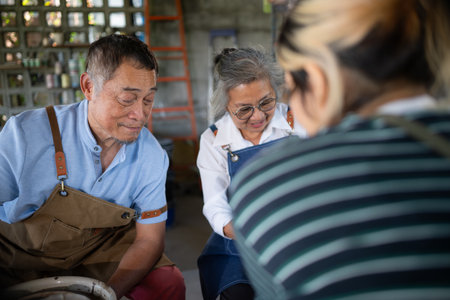 Portrait of a senior Asian couple doing activities together in the pottery workshop.の写真素材