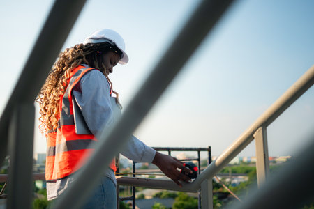 Young female engineer or architect working on construction siteの写真素材