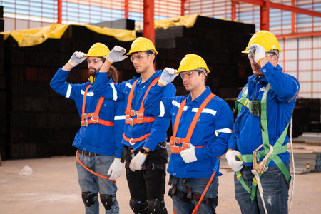 Portrait of a team of industrial workers standing together in a warehouseの写真素材