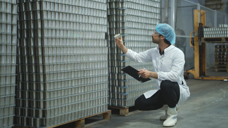 Production control supervisor inspects and controls the operation of each step in the production line of a canned fish factoryの写真素材