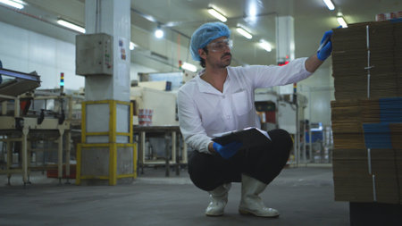 The production supervisor inspects the canned fish boxesの写真素材