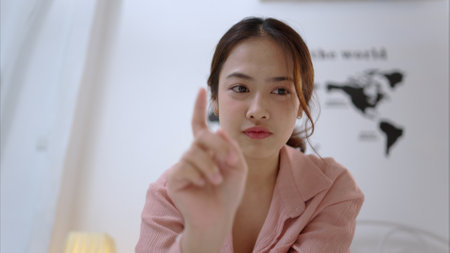 Asian young woman relaxing before bedtime on the bed in the bedroomの写真素材
