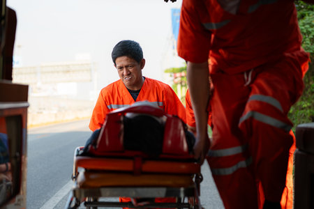 The paramedic  is assisting an injured man in an emergency situation on the road.の写真素材