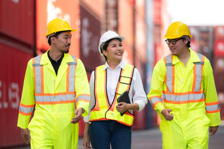 Group of engineers working with laptop in the container yard. This is a freight transportation and distribution warehouse.の写真素材