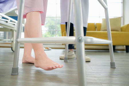 Following a period of treatment, the doctor examines the patient's legs and knees.の写真素材