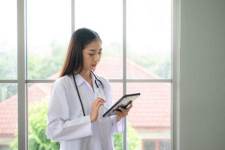 Portrait of female medical and team discuss a case study involving disease therapy for a hospital patient.の写真素材