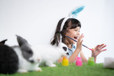 Easter bunny fun with little children the beauty of friendship between humans and animalsの写真素材