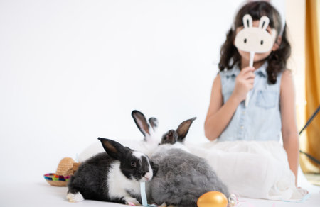 Easter bunny fun with little children the beauty of friendship between humans and animalsの写真素材