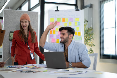 Multiethnic young business people working together in modern office, Collaborate to designing an application for use on the internet network.の写真素材