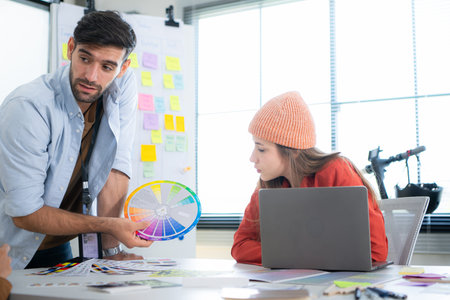Multiethnic young business people working together in modern office, Collaborate to designing an...