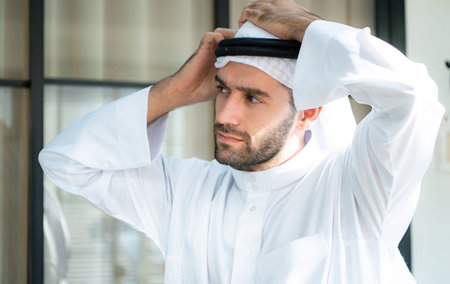 Portrait of a handsome young Arabic man in traditional clothes