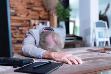 An elderly businessman suffered a sudden heart failure at work.の写真素材