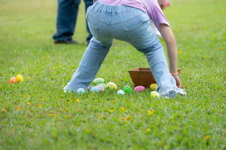 Children enjoying outdoor activities in the park including a run to collect beautiful Easter eggs.