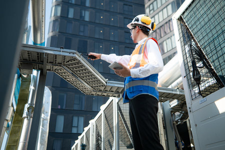 Engineers inspect the completed air conditioning and water systems to continue verifying their functionality.の写真素材