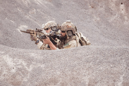 Soldiers in camouflage military uniforms carrying weapons, Reconnaissance missions in rugged...