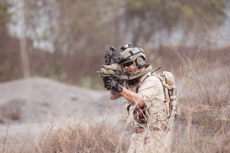 Soldiers in camouflage military uniforms carrying weapons, Reconnaissance missions in rugged...