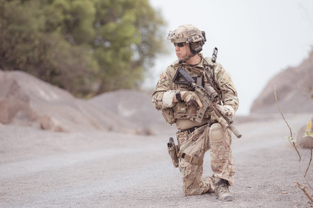 Soldiers in camouflage military uniforms carrying weapons, Reconnaissance missions in rugged...