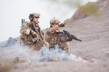 Soldiers in camouflage military uniforms carrying weapons, Reconnaissance missions in rugged...